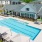 Saltwater pool with crystal clear water, surrounded by lounge chairs and a stylish cabana