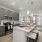 Open-concept kitchen with granite countertops, subway tile backsplash, and pendant lighting.