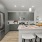 Open-concept kitchen with granite countertops, subway tile backsplash, and pendant lighting