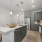 Open-concept kitchen with granite countertops, subway tile backsplash, and pendant lighting