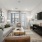 Spacious living room featuring a grey sectional sofa, coffee table, and wall-mounted TV.