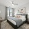 Master bedroom with king-sized bed, floor-to-ceiling windows, and walk-in closet.