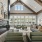 Elegant clubhouse with modern furnishings, a cozy fireplace, and large windows offering plenty of natural light