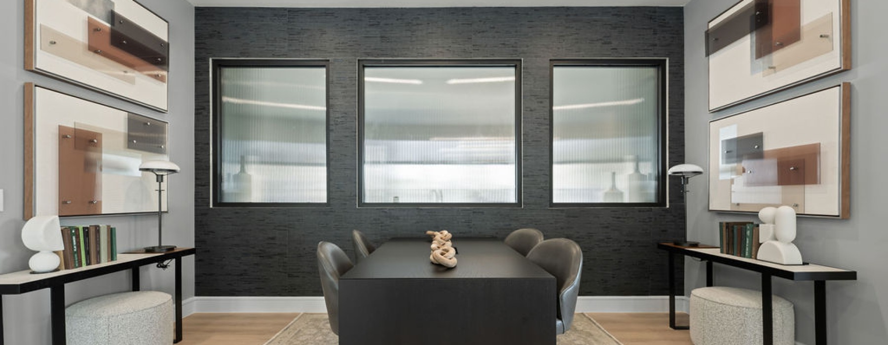 Modern coworking space featuring communal tables, cozy lounge areas, and vibrant wall art.