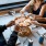 people grabbing slices of pizza in restaurant