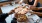 people grabbing slices of pizza in restaurant