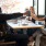 friends clink beer cans in restaurant